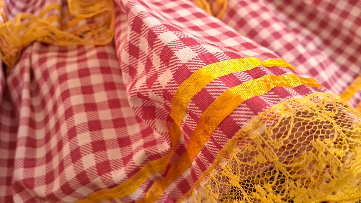 Red and white checkered fabric with yellow lace trim